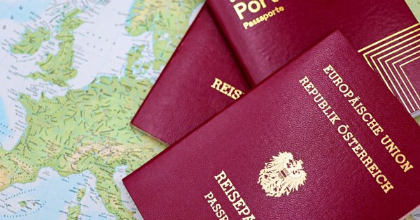 An Austrian passport resting on a map of Europe