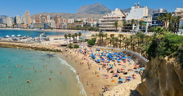 Rainbow flags and beachfront promenade in a Spanish coastal resort town