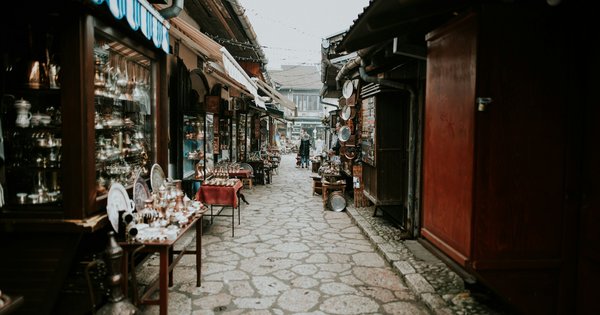 A narrow cobbled lane in Sarajevo's old bazaar lined with shops selling copper coffee pots and trays
