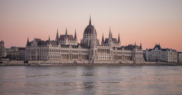The Hungarian Parliament building seen across the Danube at dusk in Budapest