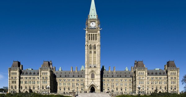 The Centre Block of Canada's Parliament in Ottawa with the Peace Tower rising above it under a blue sky