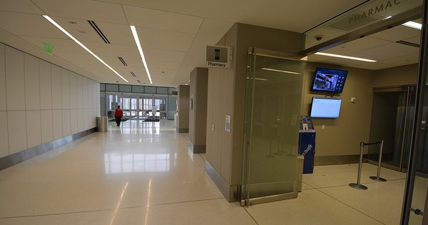 A quiet interior corridor in a large modern hospital building