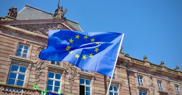 The blue flag with a circle of twelve gold stars, used by both the Council of Europe and the EU, flying in Place Kléber, Strasbourg
