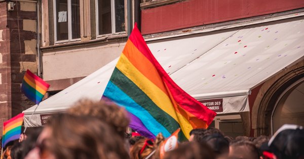 Rainbow Pride flag against a Parisian backdrop in France