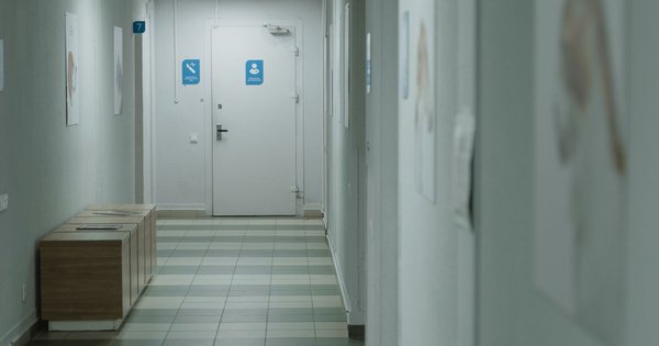 A hospital corridor with natural light coming through windows
