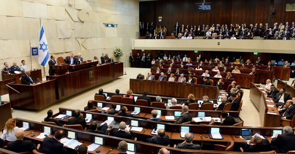 The plenum hall of the Knesset, Israel's parliament, in Jerusalem, with lawmakers seated in rows of desks