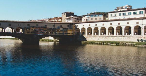 The Ponte Vecchio and the Arno River in Florence, Italy at sunset