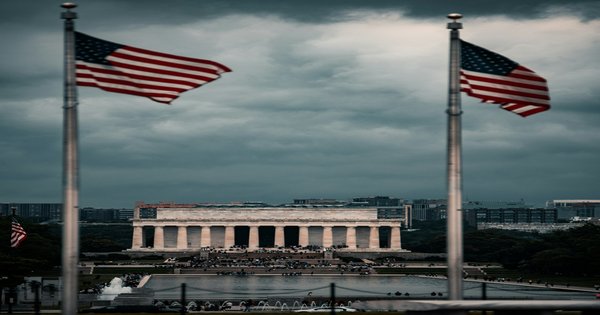A row of American state flags outside a government building