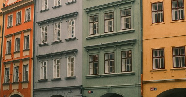 Rainbow pride flags along a cobblestone street in Prague's Old Town