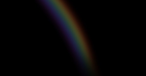 A rainbow flag against a grey, overcast sky