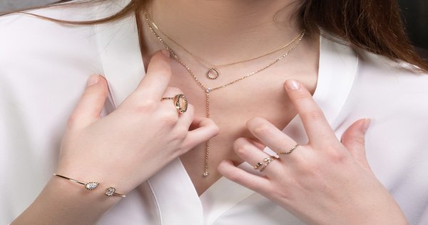A close-up of hands with a ring, resting together