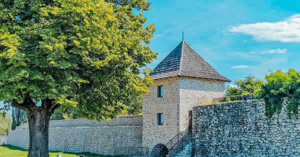 The stone walls and tower of Kastel fortress in Banja Luka under a bright blue sky