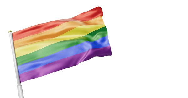 Rainbow flag against a blue sky