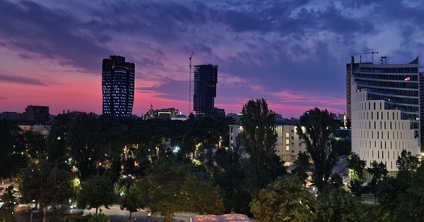 Evening light over a Tirana boulevard with Pride posters on a lamppost